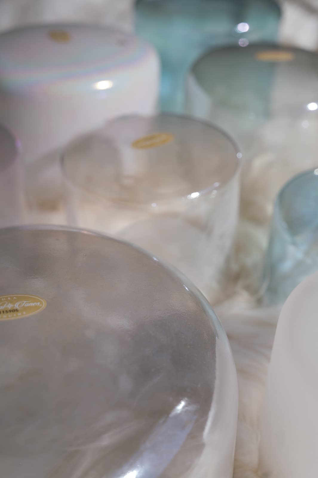 Crystal singing bowls in soft pastel tones